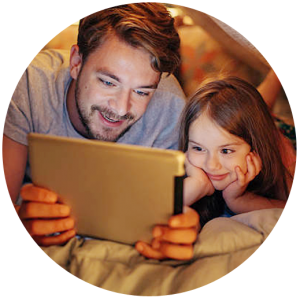 Father and daughter looking at a tablet computer